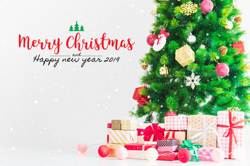 Fototapeta na wymiar Christmas and Happy new year 2019 on christmas tree and gift box decoration ornament background with snowfall.