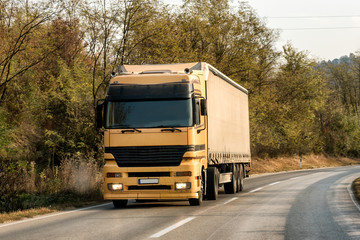Yellow Truck transporter on a Mountain Road