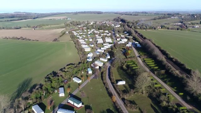 Aerial view of mobile homes partlty used as permanent houses but aslo for holiday or temporary accommodation they are left often permanently or semi-permanently in one place but can be moved 4k