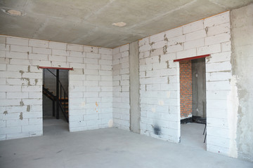 Empty room interior build with plastering wall, drywalls, stucco, metal door lintel.