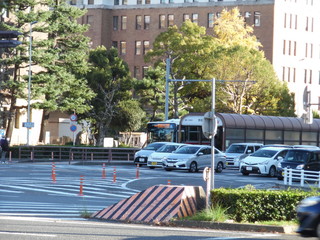 A bus and the cars which run in in front of Nagoya city hall