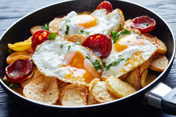 spanish fried eggs with potatoes and sausages