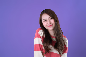 Fototapeta premium Happy Chinese woman, winter clothing, purple background