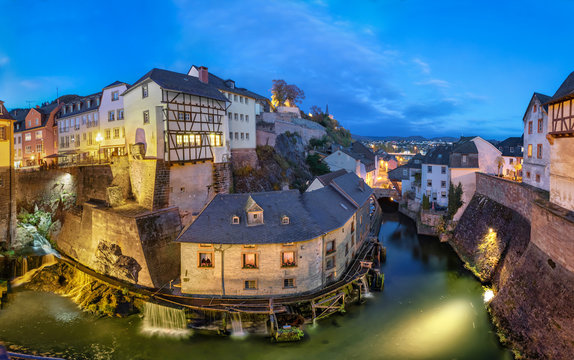 Saarburg, Germany. Cityscape with Leuk River and old historic watermills at dusk
