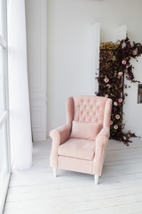 Pink armchair in living room.
