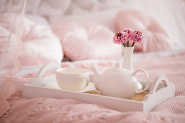 White dishes on pink blanket, breakfast.