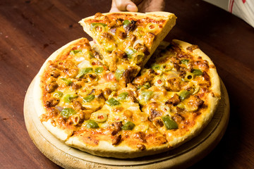 Pan Pizza slice take from hand