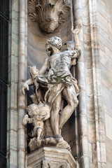 Fototapeta premium Statue of Saint on the facade of the Milan Cathedral, Duomo di Santa Maria Nascente, Milan, Lombardy, Italy