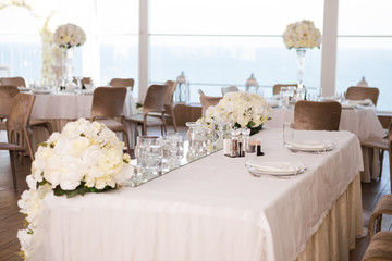 Table set for wedding reception with flowers.