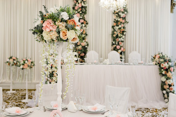 Fototapeta na wymiar Wedding banquet in restaurant, tables with flowers