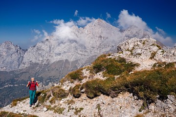 A mountaineer woman, happy to have successfully completed the climb of a mountain path.