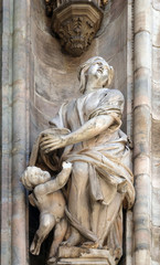 Fototapeta premium Statue of Saint on the facade of the Milan Cathedral, Duomo di Santa Maria Nascente, Milan, Lombardy, Italy