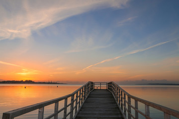 Fototapeta na wymiar beautiful pier with romantic seascape at sunset