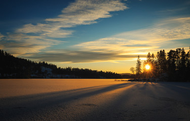 Sunset light above frozen lake Jonsvatnet.