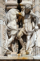 Obraz premium Atlantes supporting the main facade of the Milan Cathedral, Duomo di Santa Maria Nascente, Milan, Lombardy, Italy