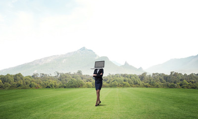 Business woman with laptop instead of head.