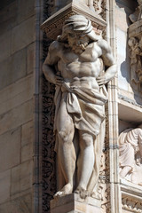 Obraz premium Atlantes supporting the main facade of the Milan Cathedral, Duomo di Santa Maria Nascente, Milan, Lombardy, Italy