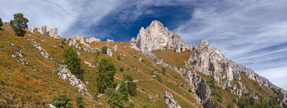 Panoramic view of the towers and spiers of the southern Grigna from the direct route, on a sunny autumn day.