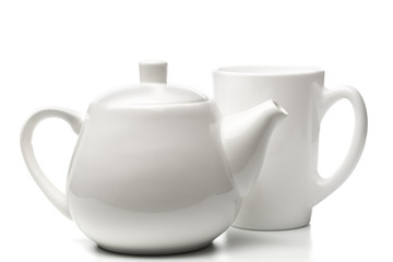 Tiny white teapot and mug on white background