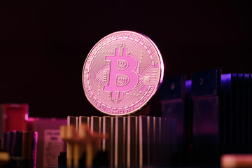 Picture of bitcoin and processor on pink background
