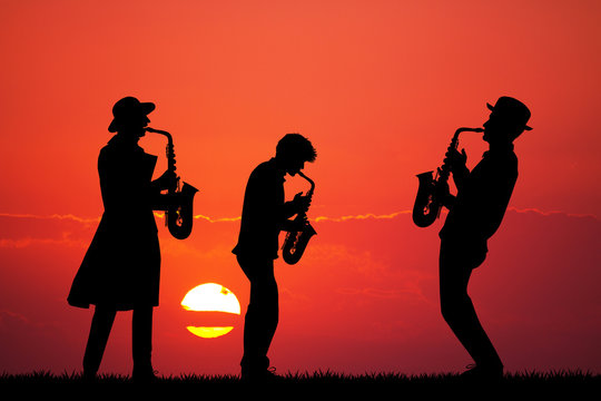 men play the sax at sunset