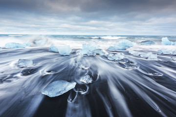 Iceberg pieces on Diamond beach near Jokulsarlon lagoon, Iceland. Landscape photography - Powered by Adobe
