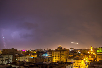 Lightning storm over city in purple light in jeddah al marwah