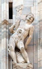Martyrdom of Saint Erasmus, statue on the Milan Cathedral, Duomo di Santa Maria Nascente, Milan, Lombardy, Italy