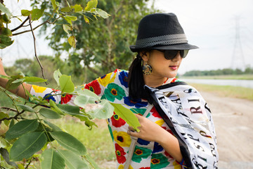 Thai woman wearing fashion colorful clothes posing portrait for take photo at outdoor