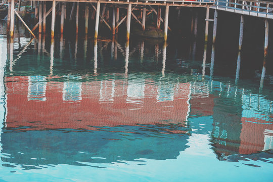 Reflection of fishing houses in the sea