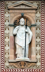 Statue of Sant'Ambrogio (Saint Ambrose) patron of the city of Milano (Milan). Detail of the clock tower of the Sforza Castle XV century (Castello Sforzesco). Lombardy, Italy