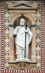 Obraz premium Statue of Sant'Ambrogio (Saint Ambrose) patron of the city of Milano (Milan). Detail of the clock tower of the Sforza Castle XV century (Castello Sforzesco). Lombardy, Italy