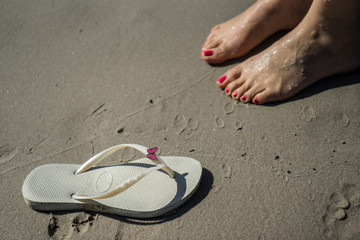 Sandal and feet on the sand
