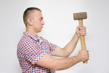Man with a sledgehammer on a white background. Work concept