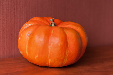 An orange pumpkin on a table