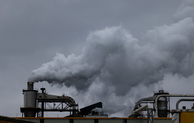 White smoke bellows out of a factory in Spain