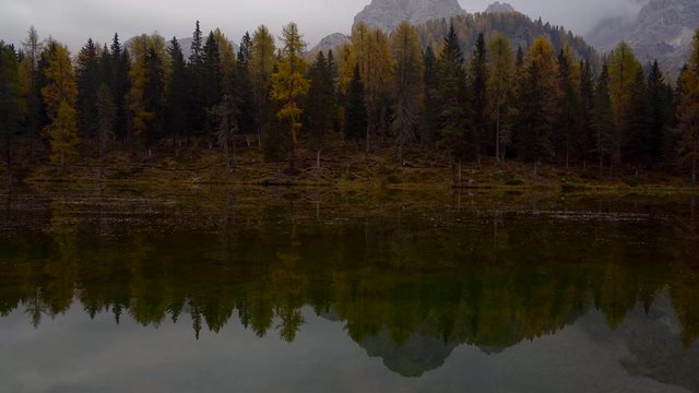 Autumn landscape of Antorno lake with famous Dolomites mountain peak of Tre Cime di Lavaredo in background in Italian Dolomites.