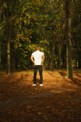 Fototapeta premium young man in autumn forest