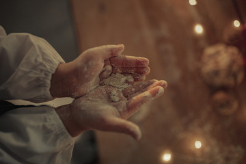 Top view to child hands stained by flour.