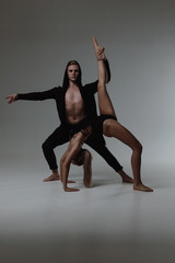 Two young modern ballet dancers in studio