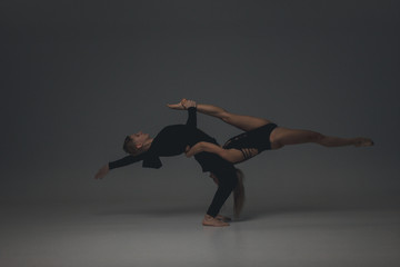 Two young modern ballet dancers in studio