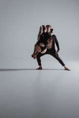 Two young modern ballet dancers in studio
