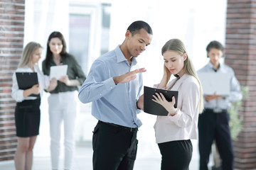 employees discussing business document standing in the office