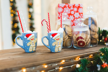 Fototapeta premium Gingerbread Man with two blue cups - Christmas Holiday breakfast Background