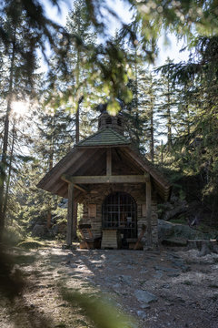 Small chapel in the forest in germany bavarian forest - Osserkapelle on the Osser. With heavy lensflare.