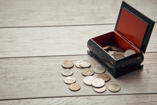 saving money, business concept. Coins on the table near the box - Powered by Adobe