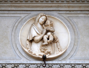 Virgin Mary with baby Jesus, relief on the portal of the Cathedral of Saint Lawrence in Lugano, Switzerland