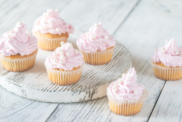 Many pink cream homemade cupcakes