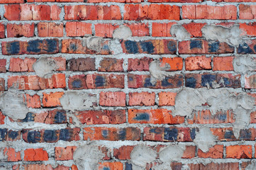Obraz premium Red old worn brick wall with concrete texture background