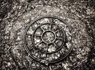 Sewerage hatchway. Black and white photo.